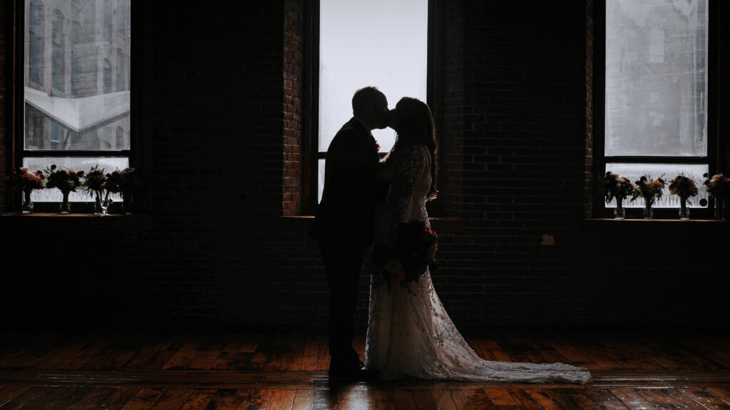 Couple Kissing in front of a window at Mill 1- Holyoke, Massachusetts 